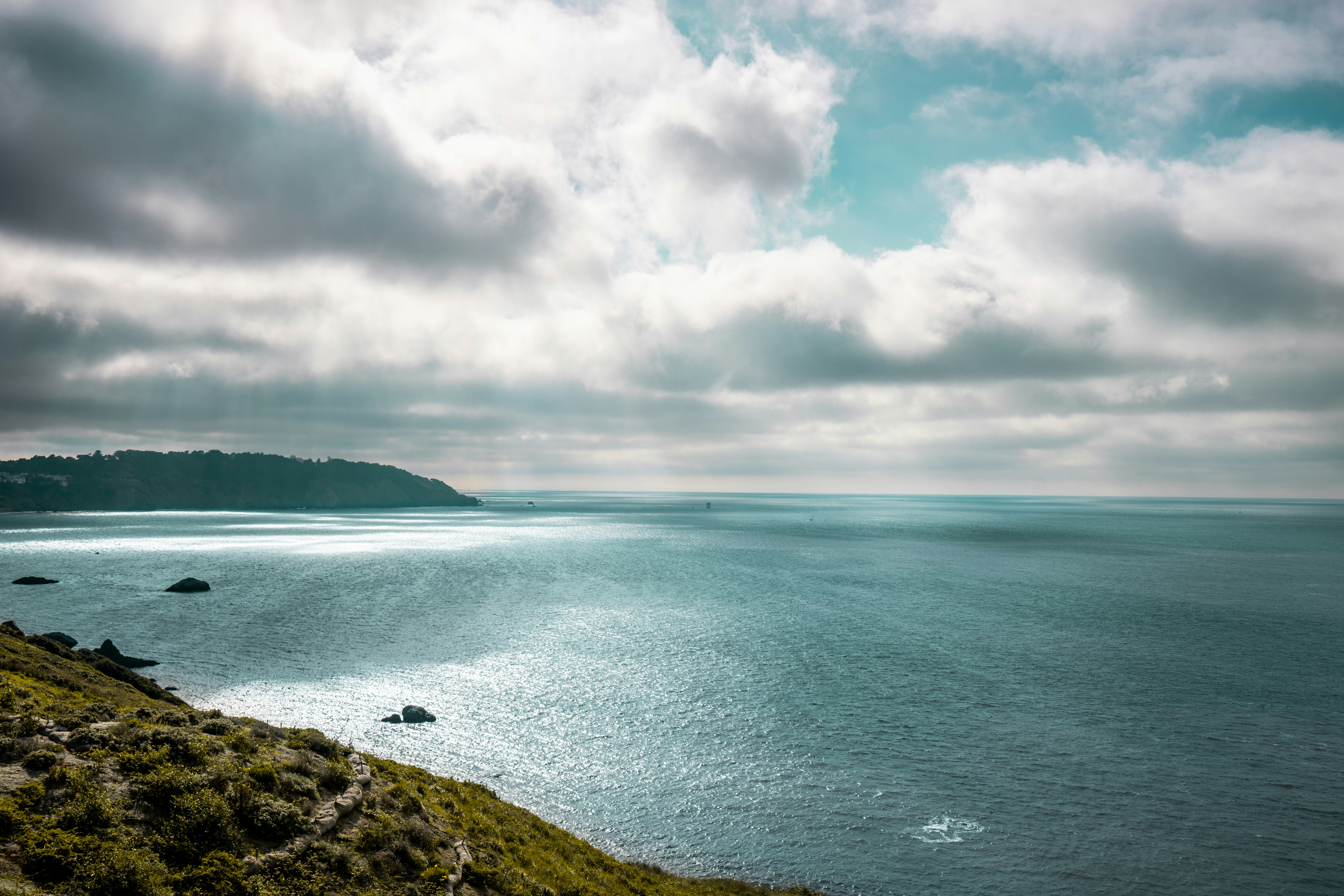 body of water under cloudy sky during daytime